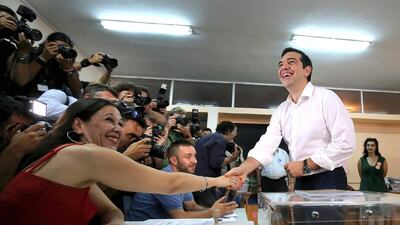 Greek prime minister Alexis Tsipras shakes hands with an official after placing his referendum vote in the ballot box in the suburbs of Athens. Christopher Furlong / Getty Images