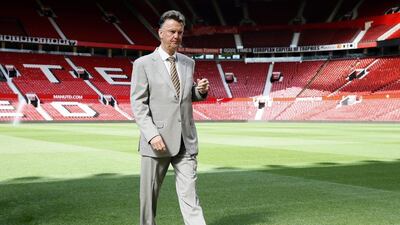 Manchester United's Louis van Gaal walks off the pitch after introducing Angel di Maria for the grounds following the midfielder's signing. Alastair Grant / AP / August 28, 2014