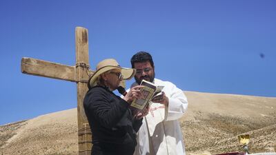 Congregant Marie Tawk reads from the Bible during the mass.