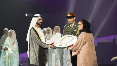 Sheikh Mohamed bin Rashid, Vice-President and Ruler of Dubai presents the Zayed Medal to Sheikha Lubna Al Qasimi, UAE Minister of State for Tolerance, who accepted it on behalf of Sheikha Fatima bint Mubarak Al Nahyan, during the Mother of the Nation Festival opening ceremony ( Ryan Carter / Crown Prince Court - Abu Dhabi )