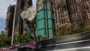Bouquet of flowers at the scene of the housing estate fire as mourners pay tribute to victims in Tai Po, Hong Kong. Reuters