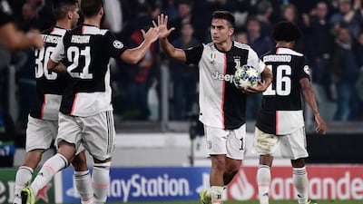 Juventus' Paulo Dybala, right, celebrates with Gonzalo Higuain after scoring during the Champions League match Juventus against Lokomotiv Moscow. AFP