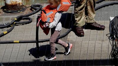 A young girl is taken in to Dover, Kent, from a small boat in the English Channel on July 18. PA