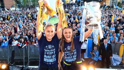 Manchester City's Steph Houghton, left, and Georgia Stanway celebrate with the Women's FA Cup and Continental Cup trophies during the Manchester City Teams Celebration Parade on on May 20, 2019. Getty Images