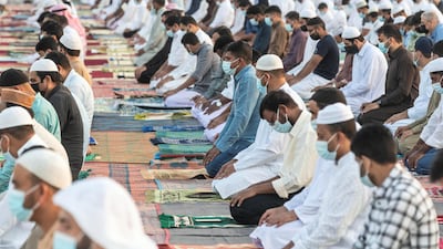 The faithful maintain physical distance while performing Eid prayers. Antonie Robertson / The National.