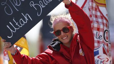 A girl on a vehicle of the sponsor’s parade hold a sign reading “Thank You Utah Beach” during the first stage of the Tour de France first stage of the Tour de France cycling race from Mont Saint-Michel to Utah Beach, France, Saturday, July 2, 2016. Peter Dejong / AP Photo