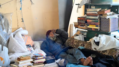 Lebanese Muhammad Al Mughrabi, an 82-year-old bookseller rests on his couch under the Iron Bridge on the Corniche Al Nahr since around two years in Beirut, Lebanon, 20 January 2022. Muhammad Al Mughrabi, studied engineering in Cairo before his circumstances changed and pushed him to live under the bridge and finally become a bookseller. The stacks of books serve as walls surrounding the place where he lives which includes a bed. He has various collections of old and new books, magazines and newspapers and survives from donations and bookselling. Lebanon has been suffering from a political and economic crisis for two years, after the disruption of petrol, diesel and electricity supplies, as well as subsidies for all oil and medicine derivatives were lifted. EPA / WAEL HAMZEH