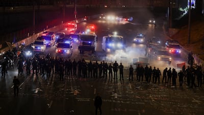 Members of security forces form a barricade to prevent protesters from blocking a road in Tel Aviv. Reuters