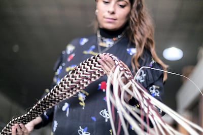 Lana El Samman inspects a khoos sample. Reem Mohammed / The National