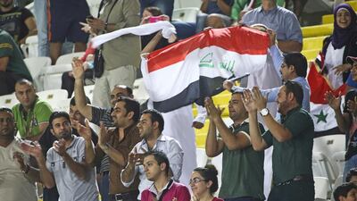 Al Ain, United Arab Emirates - October 22 2013 - Iraqi fans celebrate as Iraq scores a goal against Mexico. Mexico beat Iraq 3-1 at the Fifa U-17 World Cup at Khalifa Bin Zayed Stadium. Section: Sport (Razan Alzayani / The National)
