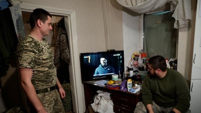 Ukrainian soldiers watch President Zelenskyy’s New Year's Eve address in a military rest house in Donetsk. Reuters