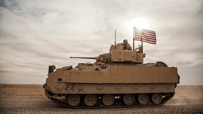 American soldiers drive a Bradley fighting vehicle during a joint exercise with Syrian Democratic Forces in north-eastern Syria in 2021. AP