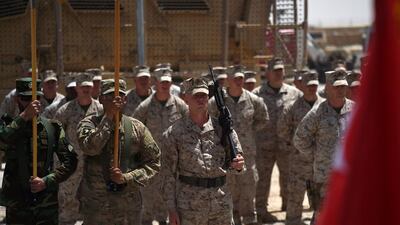 US marines and Afghan soldiers carry flags during a handover ceremony at Leatherneck Camp in Lashkar Gah in the Afghan province of Helmand on April 29, 2017. Wakil Kohsar / AFP