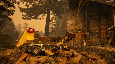 Toy trucks sit on the rubble of a burned home along Empire Flat Road. Bloomberg