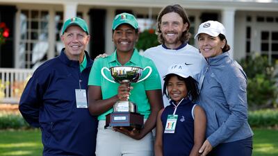 Maya Palanza Gaudin poses with the Drive, Chip and Putt trophy alongside father Stephen Gaudin, left, mother, Cassandra, right, sister Willa, second right, Tommy Fleetwood at Augusta National Golf Club. EPA