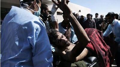 A wounded fighter is brought into the Ras Lanuf Hospital from the battle in Ben Jawad yesterday.