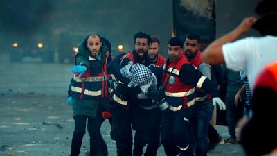 Palestinian medics evacuate a wounded Palestinian protester during clashes between Israeli troops and Palestinian demonstrators in Ramallah. AFP