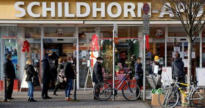 People queue to receive free face masks in Berlin. Reuters