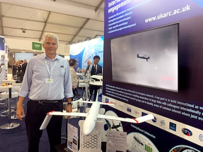 Professor Jonathan Cooper of Bristol University at the UK's Farnborough International Airshow with a model of a plane fitted with folding wing tips. The National