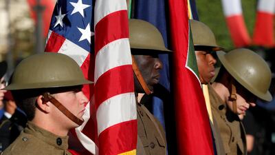 U.S. troops, with soldiers wearing WWI helmets, are seen prior to the start of the traditional Bastille day military parade on the Champs-Elysees in Paris, France, July 14, 2017. REUTERS/Yves Herman