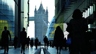 City workers head to work during the morning rush hour in Southwark in central London. The UK jobless level fell to 6.9% in February. Toby Melville / Reuters