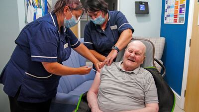 Care home resident Jeff Collins receives a Covid booster vaccination at a nursing home in Bury, northern England. PA