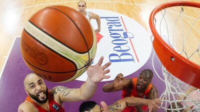 Angola’s Reggie Moore, left, jumps for the ball during the 2016 FIBA World Olympic Qualifying basketball match between Puerto Rico and Angola at the Kombank Arena in Belgrade, Serbia. Pedja Milosavljevic / AFP Photo