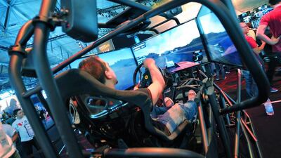 A visitor plays The Crew car and driving game. Henning Kaiser / AFP