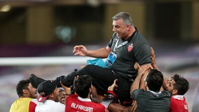 Al Ahli coach Cosmin Olaroiu is hoisted in the air by his team after defeating Al Ain during their Asian Champions League match at Hazza bin Zayed Stadium in Al Ain on May 27, 2015. Christopher Pike / The National