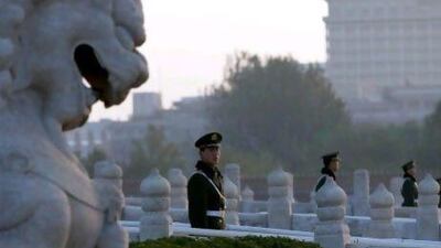 Chinese paramilitary policemen guard the bridges leading to Tiananmen Gate in Beijing. Authorities want no more surprises as party leaders convene in the capital to decide the country’s new leaders.