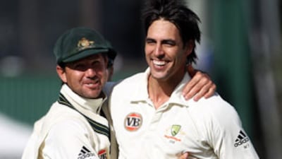 Mitchell Johnson is congratulated by captain Ricky Ponting on the wicket of Ross Taylor during day four at Seddon Park.