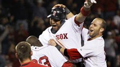 Boston's Alex Gonzalez, second right, celebrates after batting in the winning run against the Angels.