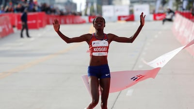 Kenya's Brigid Kosgei celebrates as she crosses the finish line to win the women's marathon, setting a new world record. Reuters