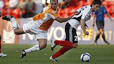 Jawad Akeel Ahannach of Umm-Salal, left, falls over Al Jazira's Rafael Sobis during the Asian Champions League match at the Mohamed Bin Zayed Stadium.