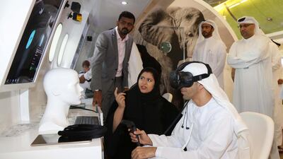 Dr Thani Al Zeyoudi, Minister of Climate Change and Environment, tries the virtual experience stand at Abu Dhabi airport. EWS-WWF