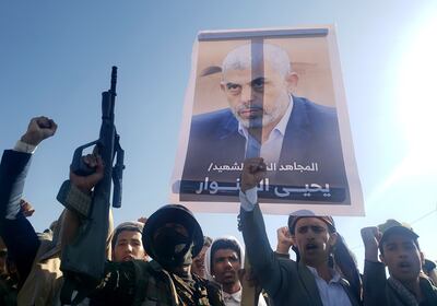 Houthi supporters carry a placard showing late Hamas leader Yahya Sinwar at a rally in Yemen's capital Sanaa on Friday. EPA