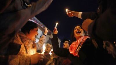 Artists hold candles during a demonstration to show solidarity outside the headquarters of the General Union of Tunisian Workers in Tunis.