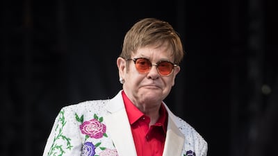 Elton John, in a white suit with a rose pattern, performs live at Twickenham Stoop on June 3, 2017 in London, England. Getty Images