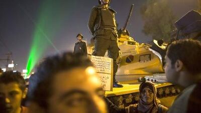Egyptian soldiers stand guard as protesters opposing president Mohammed Morsi gather during a demonstration at the presidential palace in Cairo.