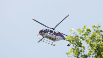 A police helicopter flies above the school where at least 10 people died in the incident, including the attacker. AFP
