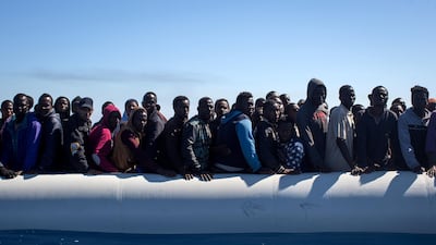 Refugees and migrants wait to be rescued from an overcrowded boat by crew members from the Migrant Offshore Aid Station (MOAS) Phoenix vessel on May 18, 2017 off Lampedusa, Italy. Chris McGrath / Getty Images