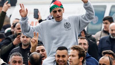 A freed Palestinian detainee is carried on another man's shoulders in Ramallah. Reuters