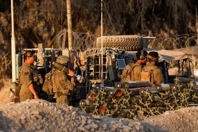 An Israeli soldier holds a mortar shell before firing into Gaza. Reuters