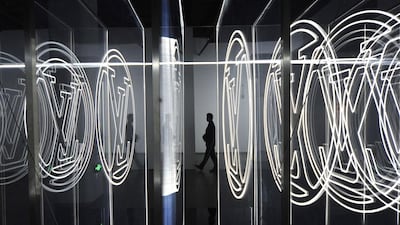 A man walks past an installation with the logo of Louis Vuitton, at an exhibition of the luxury brand's new products, inside a shopping mall in Shanghai, on September 9, 2014. Reuters
