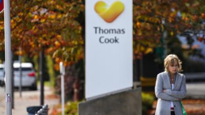 A woman passes next to the logo of the travel company Thomas Cook and a street sign in front of the headquarters of the German branch of Thomas Cook in Oberursel, Germany, 25 September 2019. British Thomas Cook's German tour operator has filed for insolvency on September 25. EPA/ARMANDO BABANI