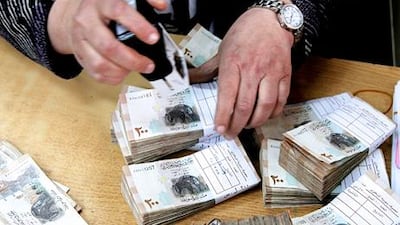 Syria's 14 private lenders, considered the crown jewels of the president Bashar Al Assad's economic modernisation plan, are weathering more than two years of unrest. Khaled Al Hariri / Reuters