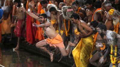 Sadhus, or Hindu holy men, jump in a holy pond during the first “Shahi Snan” (grand bath). Shailesh Andrade / Reuters