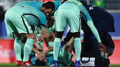 Barcelona's Sergio Busquetsis attended to by teammates on the pitch after being injured against Eibar on January 22, 2017 in Eibar, Spain. David Ramos / Getty Images