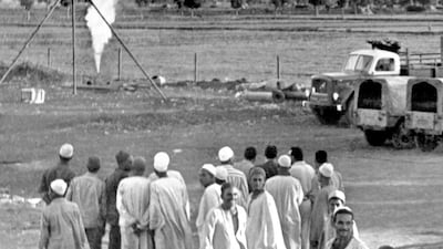 Egyptian farmers look at a towering flame at an outburst of natural gas discovered by Eni in this 1966 photo. Aly Mahmoud / AP Photo