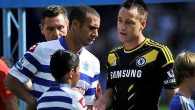 Anton Ferdinand, left, the QPR defender, avoids shaking hands with Chelsea's John Terry who was cleared of a racism charge from last season. Glyn Kirk / AFP